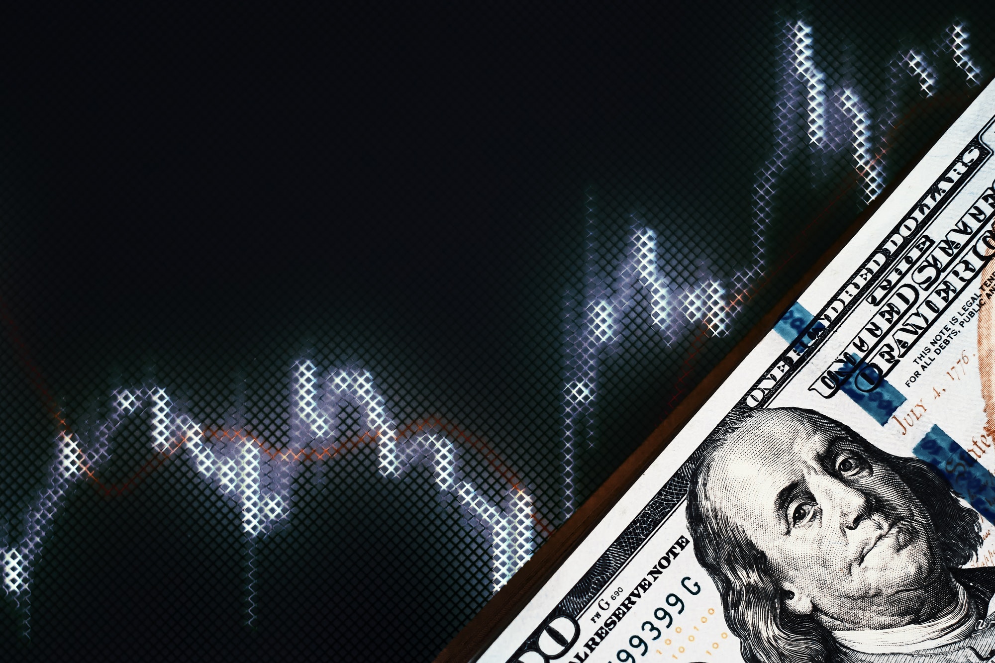dollar banknote at background with a stock market chart. Forex trading concept, toned photo